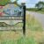 A roadside sign reads Sturton Le Steeple, The Town on the Street next to a rural road.